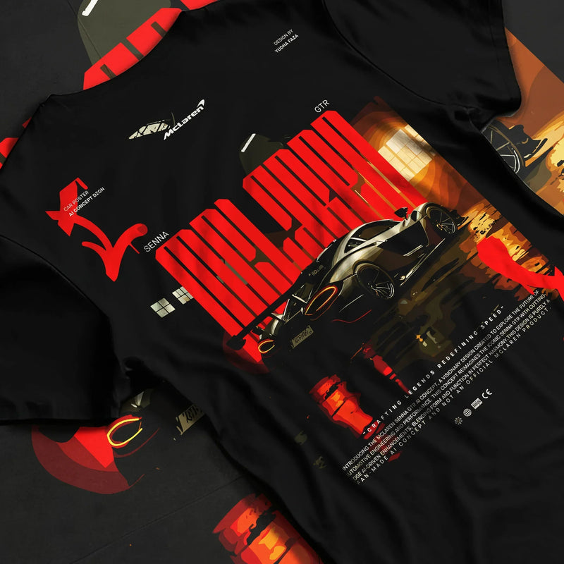 Black T-shirt laid flat with natural fabric folds, featuring McLaren SENNA track street racing performance motorsport graphic.