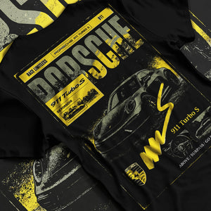 Black T-shirt laid flat with natural fabric folds, featuring Porsche 911 Turbo S rs 911 turbo racing german street classic graphic.