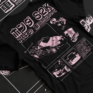 Black T-shirt laid flat with natural fabric folds, featuring Honda S2000 jdm japanese street retro racing performance graphic.