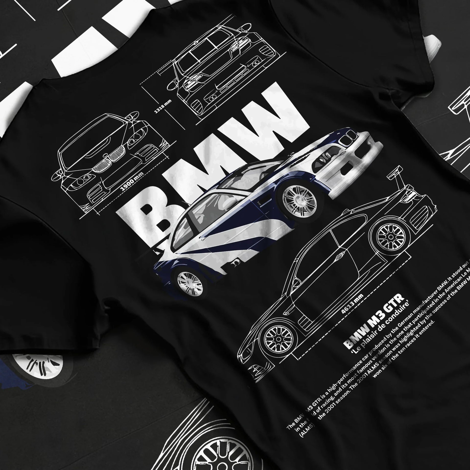 Black T-shirt laid flat with natural fabric folds, featuring BMW racing drift german tuner enthusiast street performance graphic.