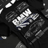 Black T-shirt laid flat with natural fabric folds, featuring BMW racing drift german tuner enthusiast street performance graphic.
