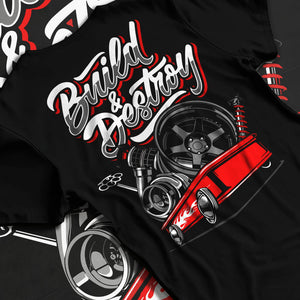 Black T-shirt laid flat with natural fabric folds, featuring racing street performance motorsport automotive enthusiast graphic.