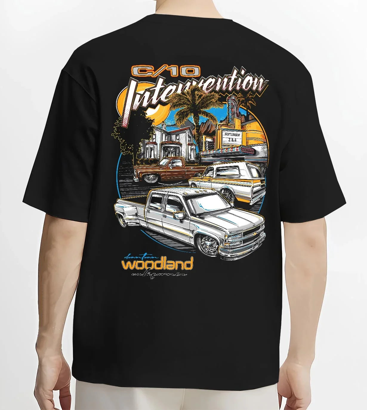 Black T-shirt worn by a male model, back view, featuring Chevrolet C10 retro vintage classic racing street performance graphic.
