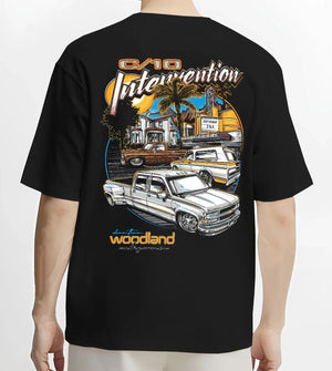Black T-shirt worn by a male model, back view, featuring Chevrolet C10 retro vintage classic racing street performance graphic.
