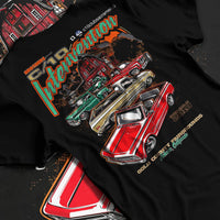 Black T-shirt laid flat with natural fabric folds, featuring Chevrolet C10 vintage classic enthusiast meet racing street graphic.