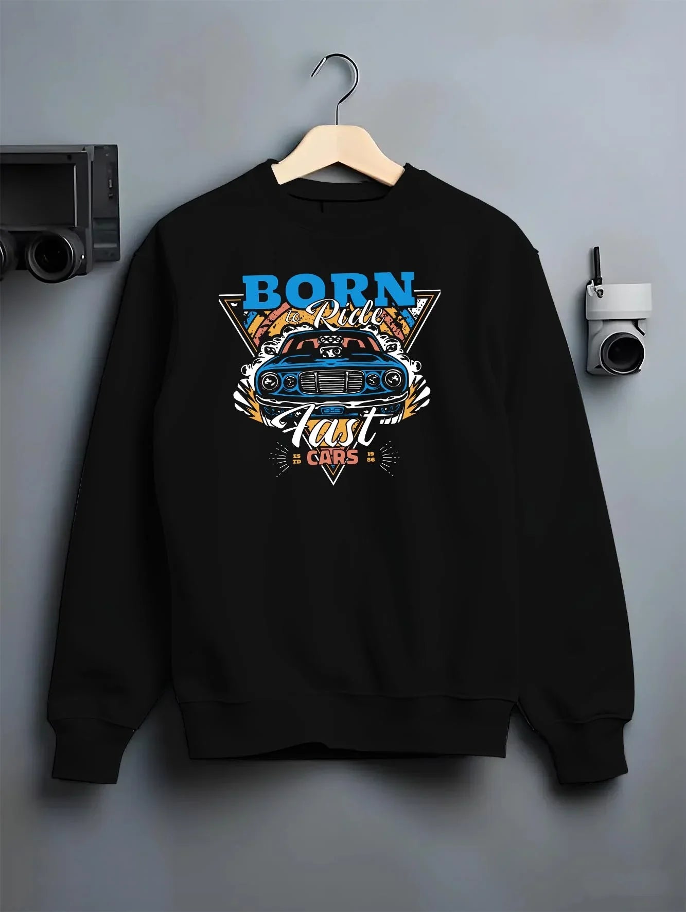 Black crewneck sweatshirt on a hanger against a grey wall, featuring Chevrolet Corvette C6 corvette racing drift muscle graphic.
