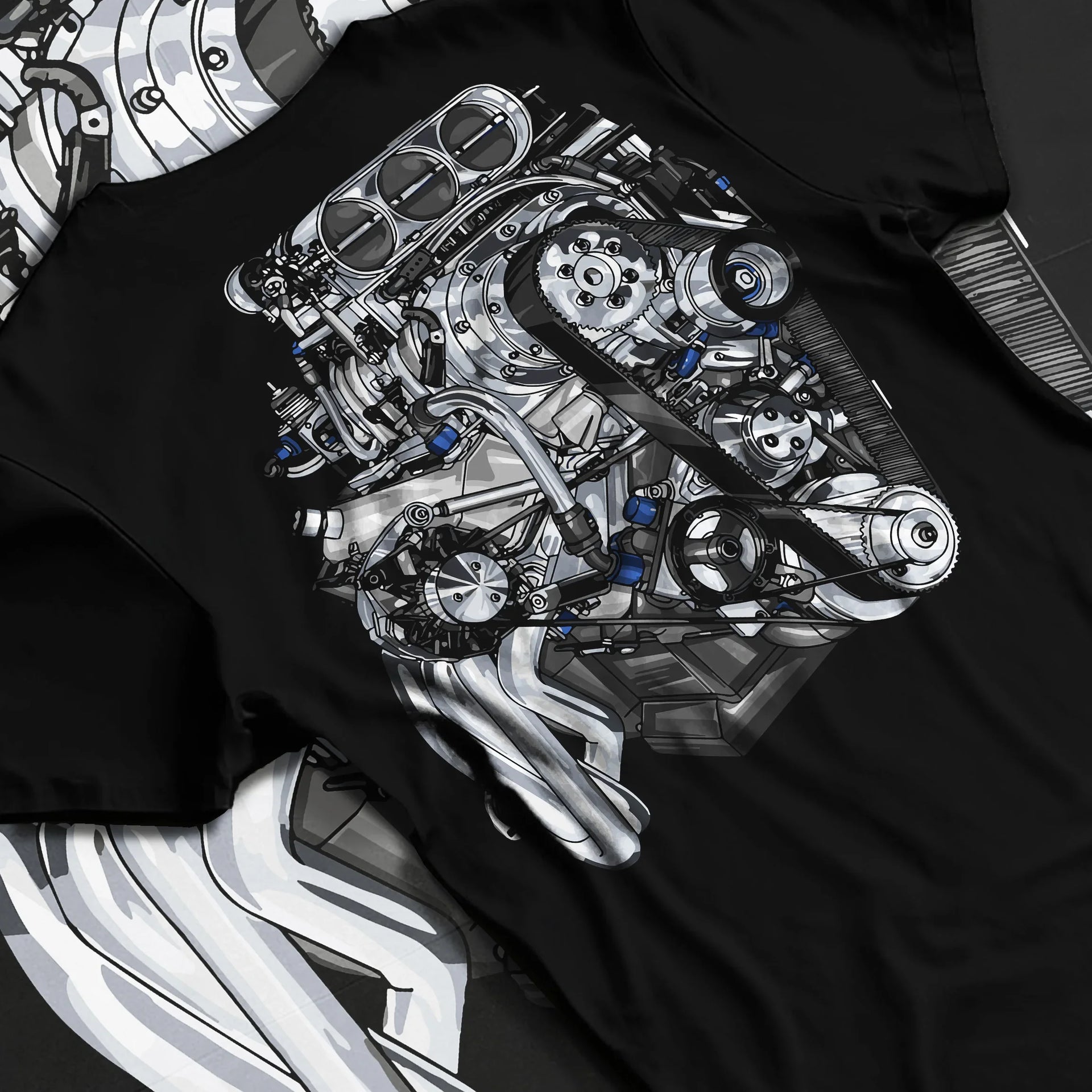 Black T-shirt laid flat with natural fabric folds, featuring turbo tuner street vintage enthusiast racing performance graphic.