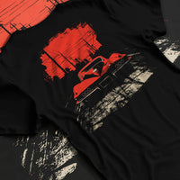Black T-shirt laid flat with natural fabric folds, featuring Chevrolet Corvette muscle retro classic enthusiast racing graphic.