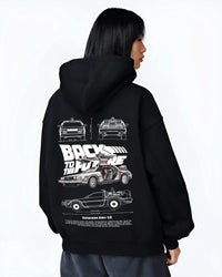 Black hoodie worn by a female model, back view, featuring DeLorean DMC-12 street retro racing performance motorsport dmcbtf.