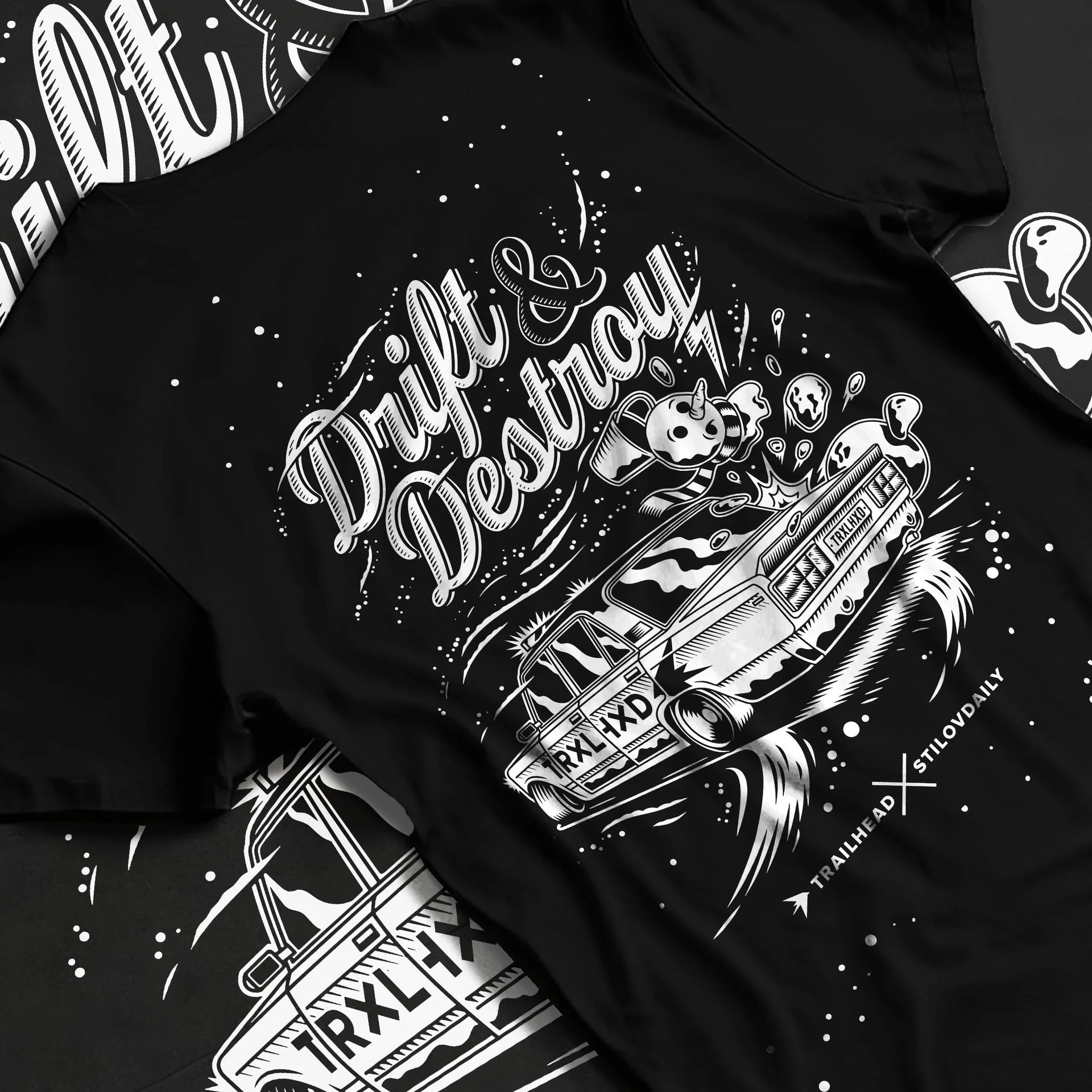 Black T-shirt laid flat with natural fabric folds, featuring racing drift street retro performance motorsport automotive graphic.