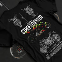 Black T-shirt laid flat with natural fabric folds, featuring Ducati Streetfighter racing street performance motorsport graphic.