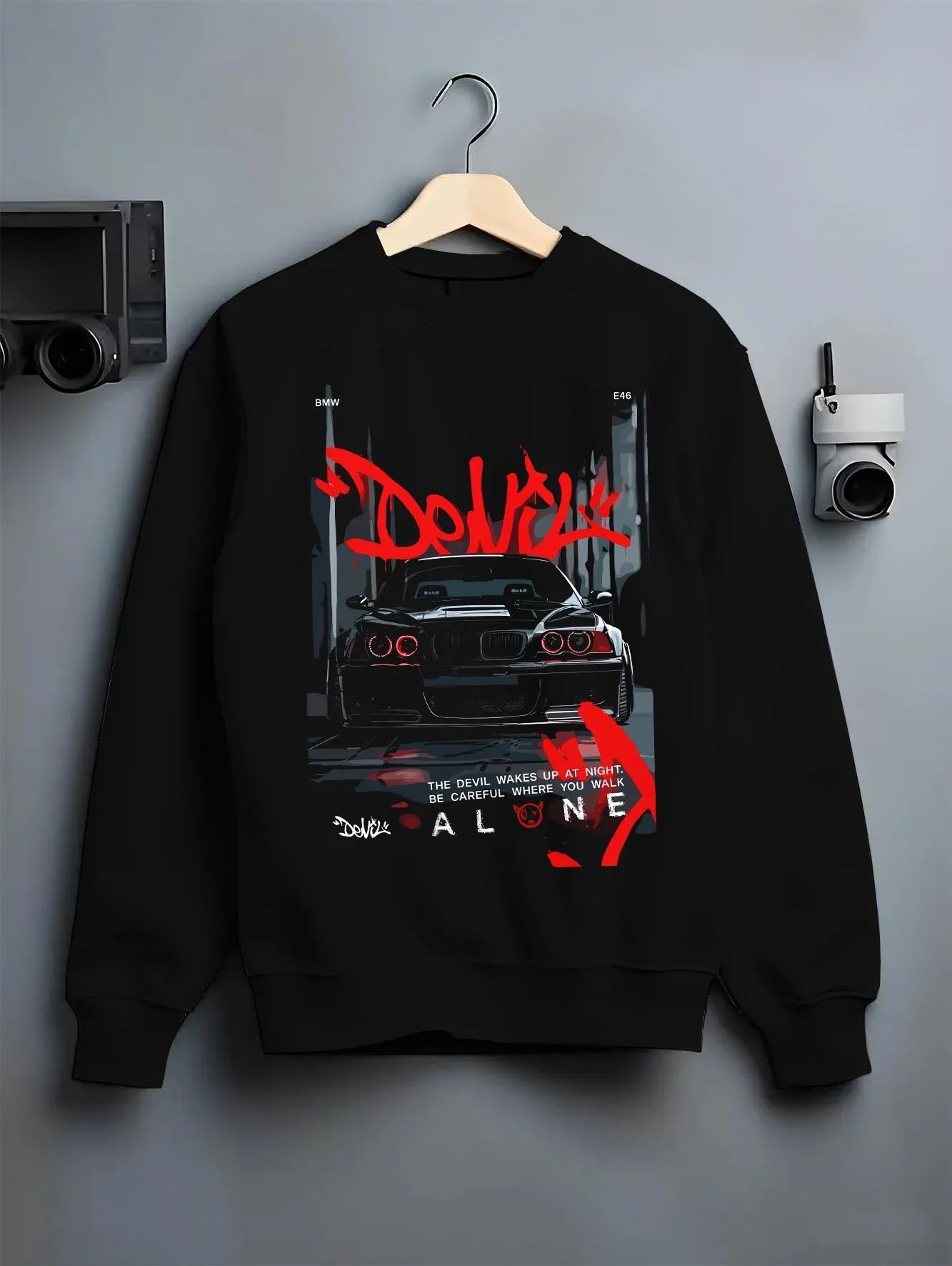 Black crewneck sweatshirt on a hanger against a grey wall, featuring BMW rs turbo racing drift motorsport euro german e28cls.