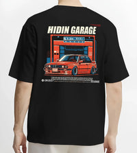 Black T-shirt worn by a male model, back view, featuring BMW E30 racing drift jdm euro street retro classic graphic.