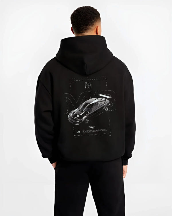 Black hoodie worn by a male model, back view, featuring BMW M3 gtr rs turbo racing le mans motorsport german street graphic.