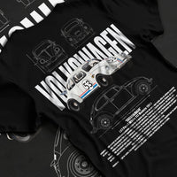 Black T-shirt laid flat with natural fabric folds, featuring Volkswagen Beetle racing classic legend street performance graphic.