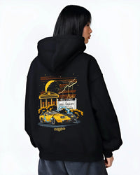 Black hoodie worn by a female model, back view, featuring racing street retro performance motorsport automotive enthusiast graphic.