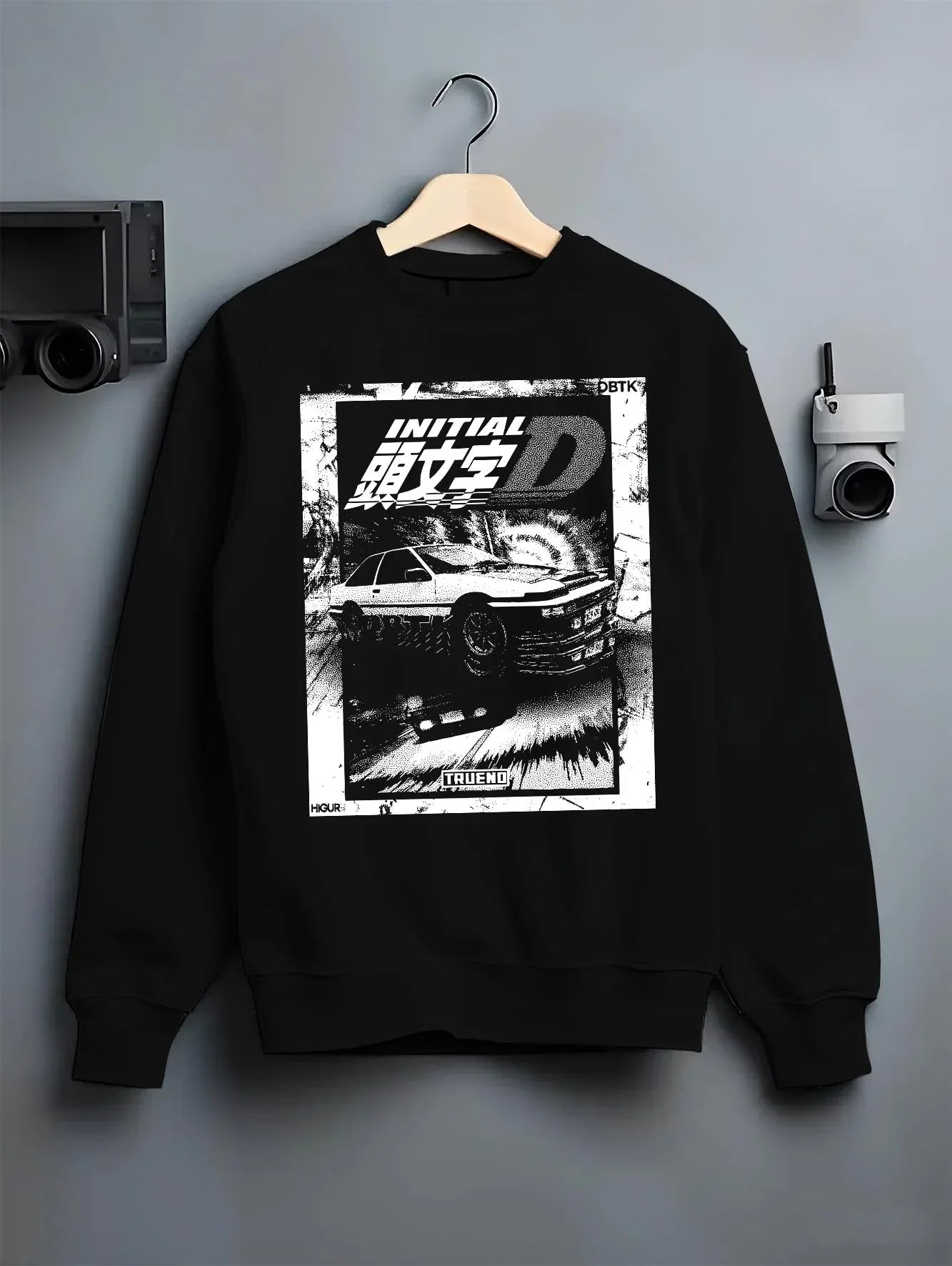 Black crewneck sweatshirt on a hanger against a grey wall, featuring racing drift jdm japanese initial d street legend graphic.