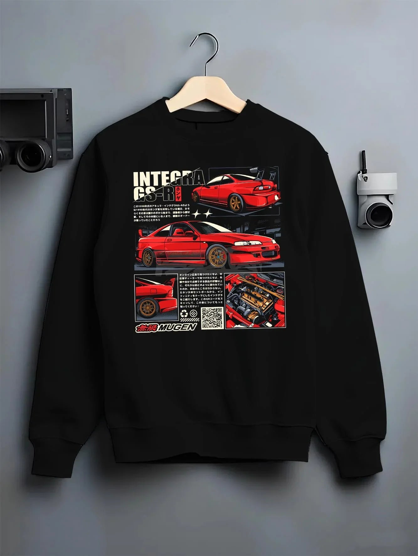 Black crewneck sweatshirt on a hanger against a grey wall, featuring Honda Integra drift jdm japanese tuning racing street graphic.
