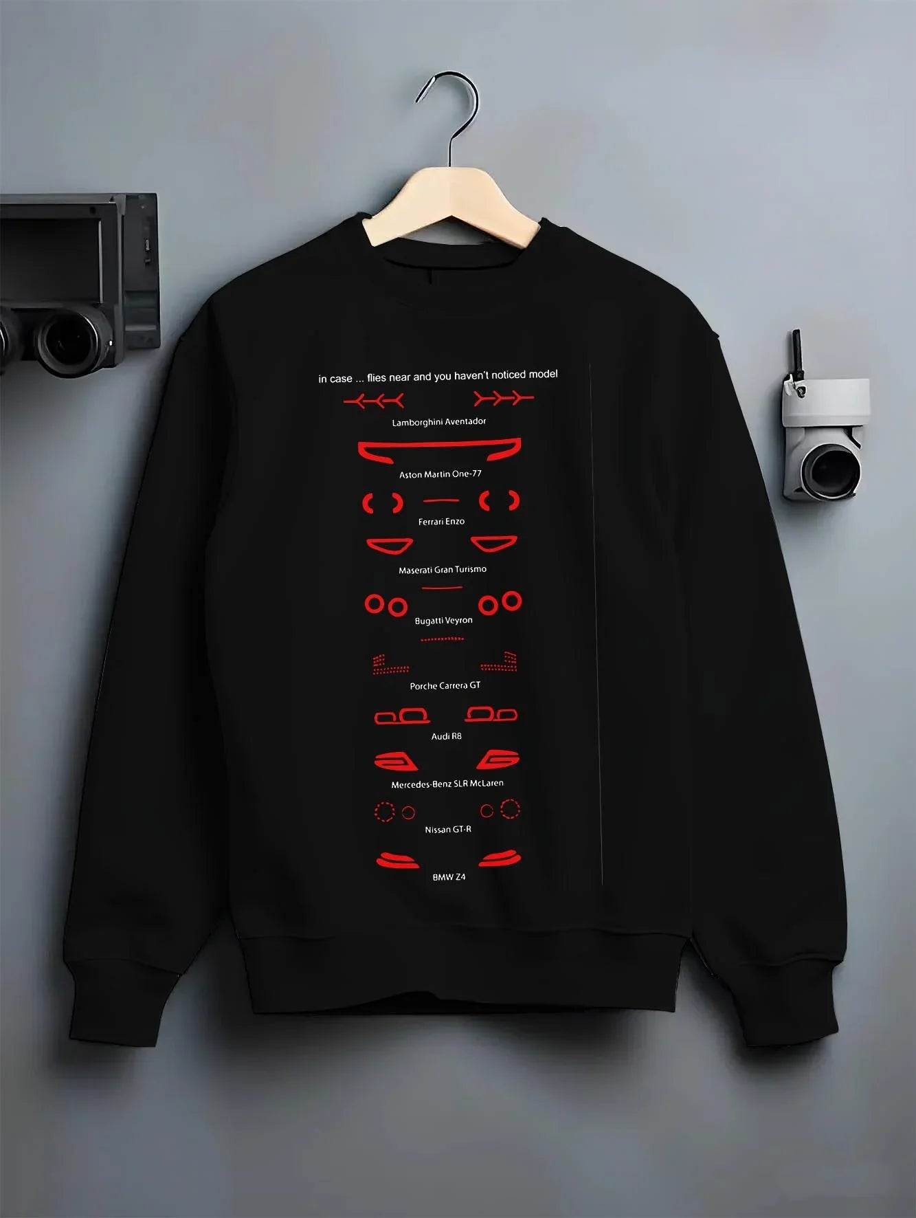 Black crewneck sweatshirt on a hanger against a grey wall, featuring Lamborghini Aventador racing italian tuning street graphic.