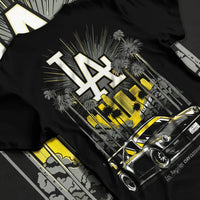 Black T-shirt laid flat with natural fabric folds, featuring racing street performance motorsport automotive enthusiast larun.