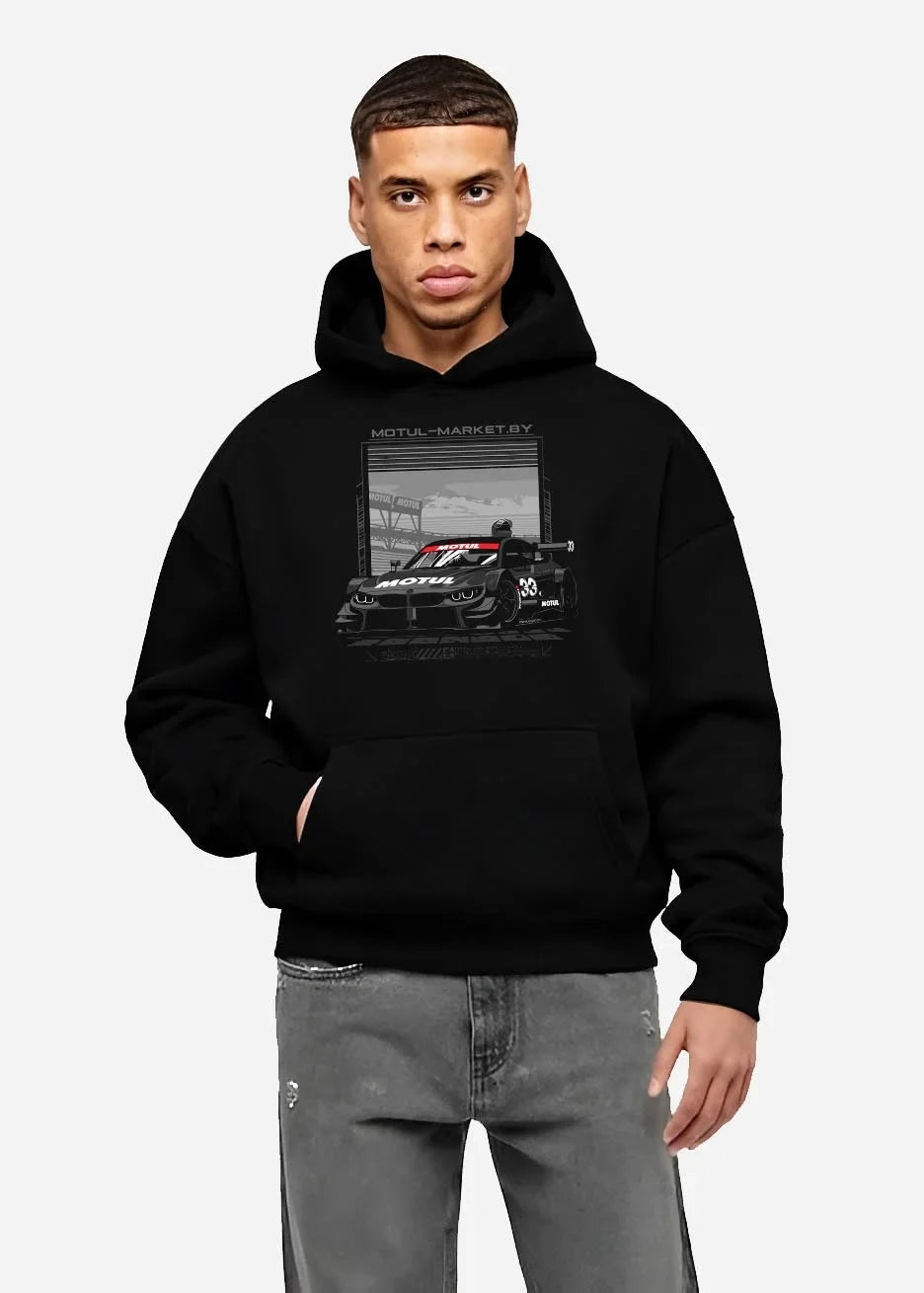 Black hoodie worn by a male model, front view, featuring BMW M4 rs turbo racing motorsport german street graphic.