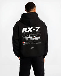 Black hoodie worn by a male model, back view, featuring Mazda RX--7 rx 7 racing drift jdm japanese street graphic mazr2.