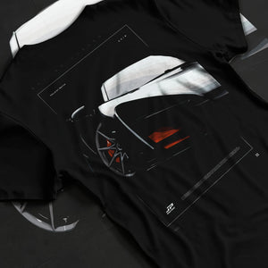 Black T-shirt laid flat with natural fabric folds, featuring McLaren F1 rs racing street retro speed enthusiast graphic.