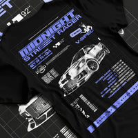 Black T-shirt laid flat with natural fabric folds, featuring NISSAN SKYLINE r34 racing race drift jdm japanese street graphic.