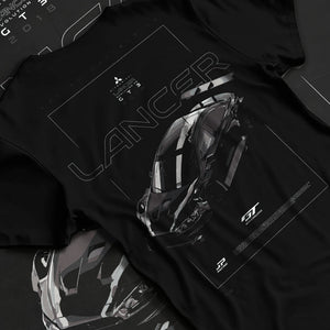 Black T-shirt laid flat with natural fabric folds, featuring Mitsubishi EVO turbo turbocharged racing drift jdm japanese graphic.