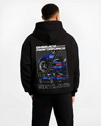 Black hoodie worn by a male model, back view, featuring Nissan Skyline R34 r34 skyline turbo jdm legend racing graphic.