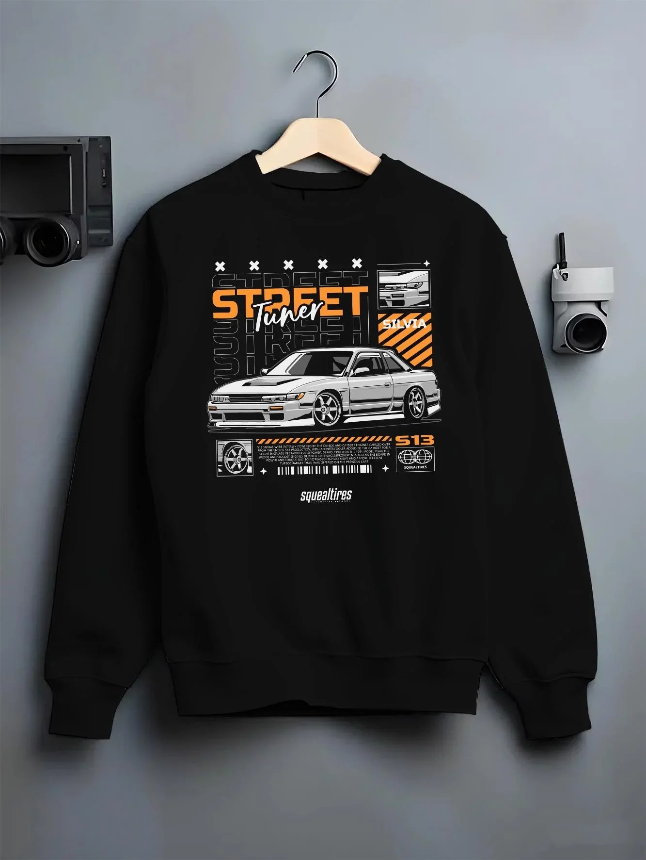 Black crewneck sweatshirt on a hanger against a grey wall, featuring Nissan Silvia S15 silvia turbo turbocharged racing graphic.