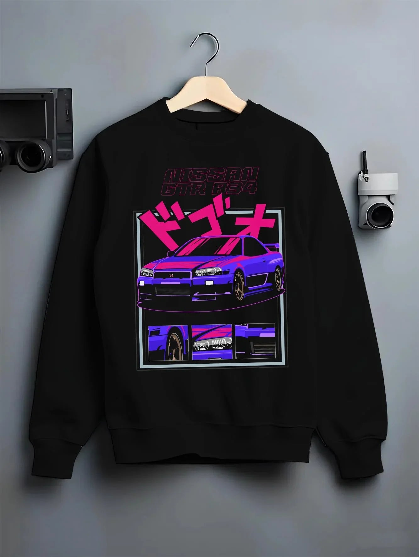 Black crewneck sweatshirt on a hanger against a grey wall, featuring Nissan Skyline turbo racing drift jdm japanese tuner graphic.