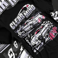Black T-shirt laid flat with natural fabric folds, featuring Nissan race drift jdm japanese tuner street midnight graphic.