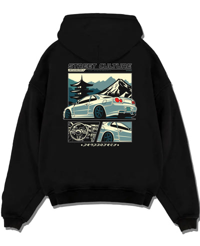 Black pullover hoodie laid flat on a white background, featuring Nissan Skyline drift jdm japanese tuner street retro graphic.
