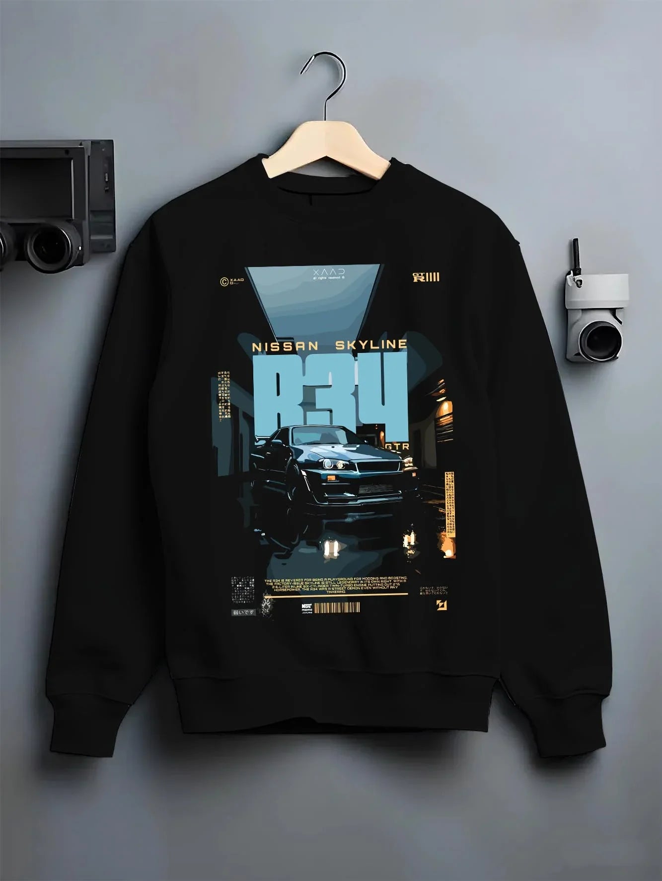 Black crewneck sweatshirt on a hanger against a grey wall, featuring Nissan Skyline R34 r34 skyline turbo racing drift jdm graphic.
