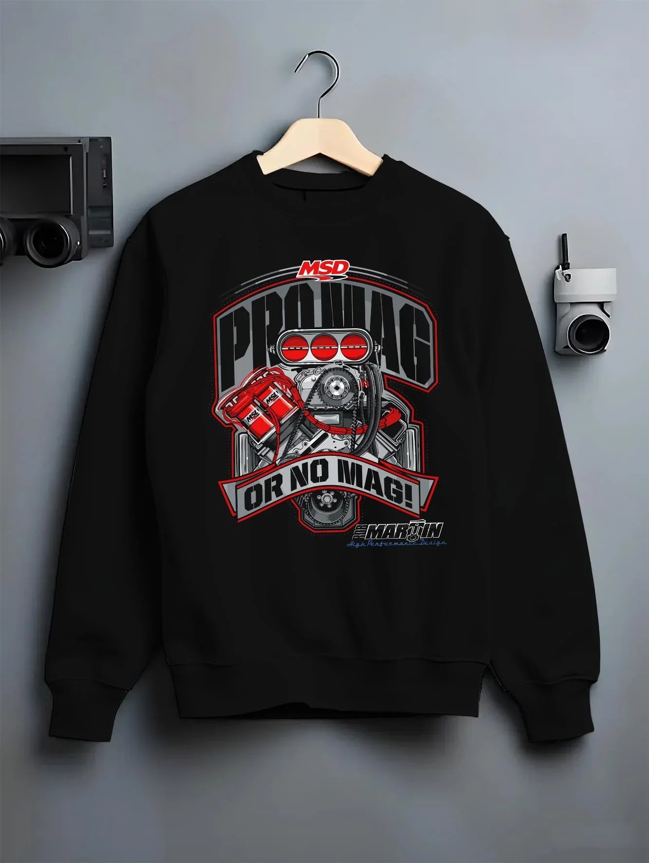 Black crewneck sweatshirt on a hanger against a grey wall, featuring turbo racing drag street performance motorsport graphic.