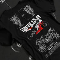 Black T-shirt laid flat with natural fabric folds, featuring Yamaha R6 racing street enthusiast performance motorsport graphic.