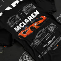 Black T-shirt laid flat with natural fabric folds, featuring McLaren SENNA rs racing motorsport speed street performance graphic.