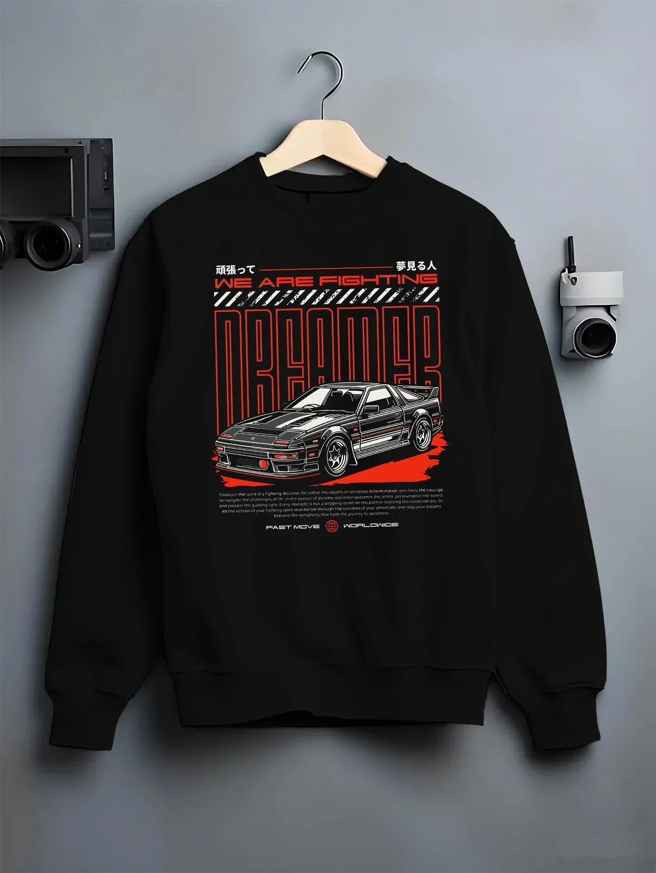 Black crewneck sweatshirt on a hanger against a grey wall, featuring Toyota CELICA turbo turbocharged racing rally jdm graphic.
