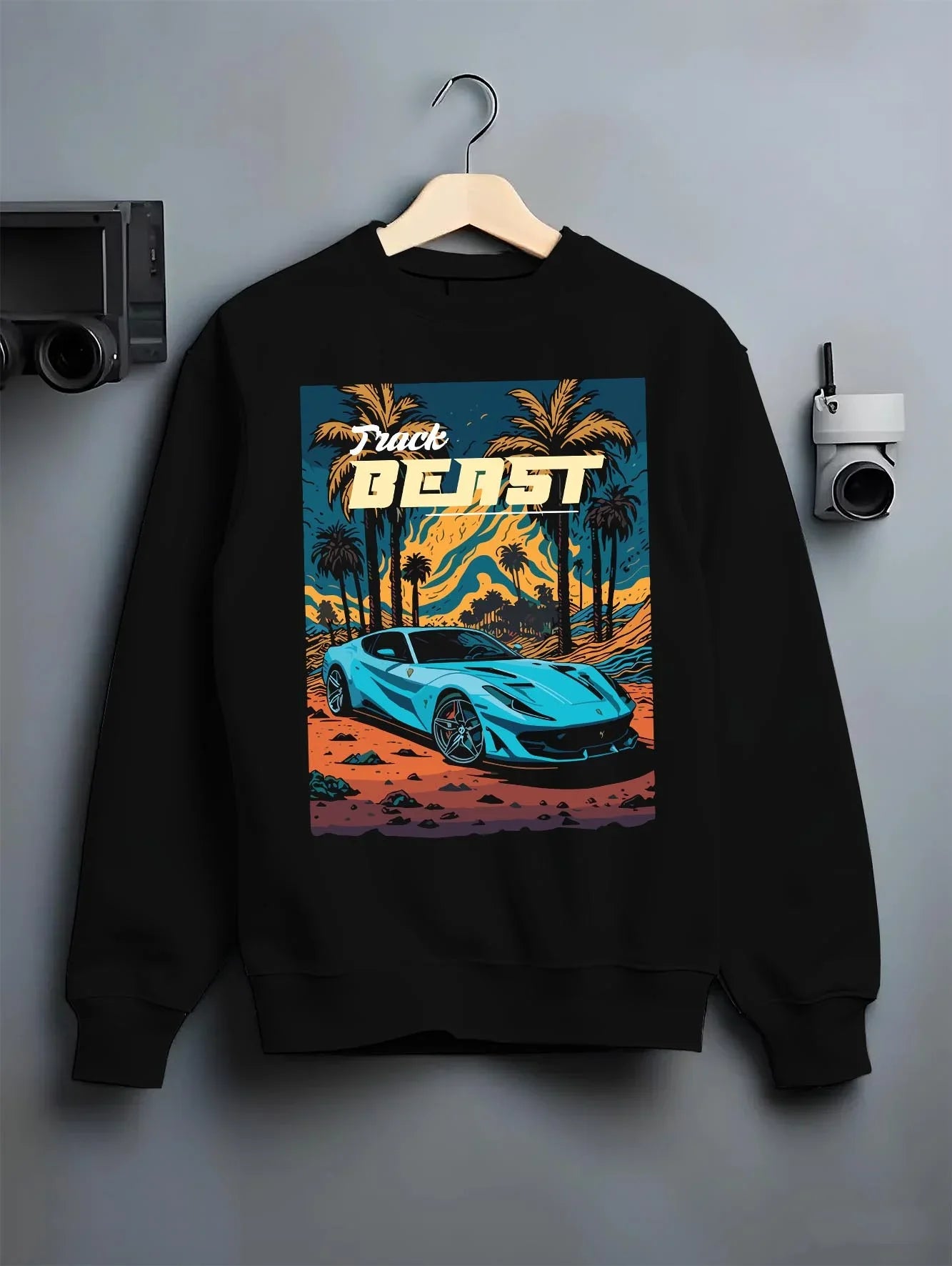 Black crewneck sweatshirt on a hanger against a grey wall, featuring rs racing track beast speed enthusiast street graphic.