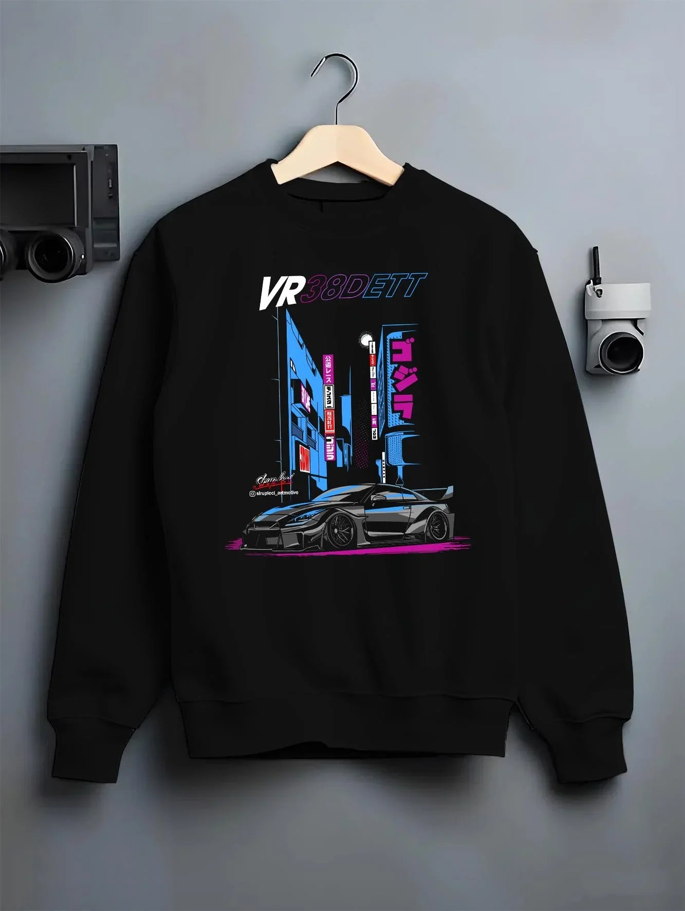 Black crewneck sweatshirt on a hanger against a grey wall, featuring Nissan 370Z turbo turbocharged racing drift jdm graphic.
